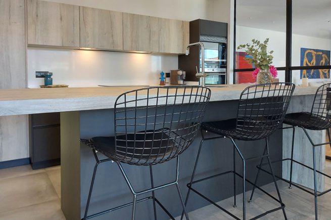 Concebemos uma cozinha com elementos em cinzento e madeira.